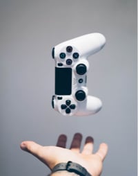 game controller floating above human hand